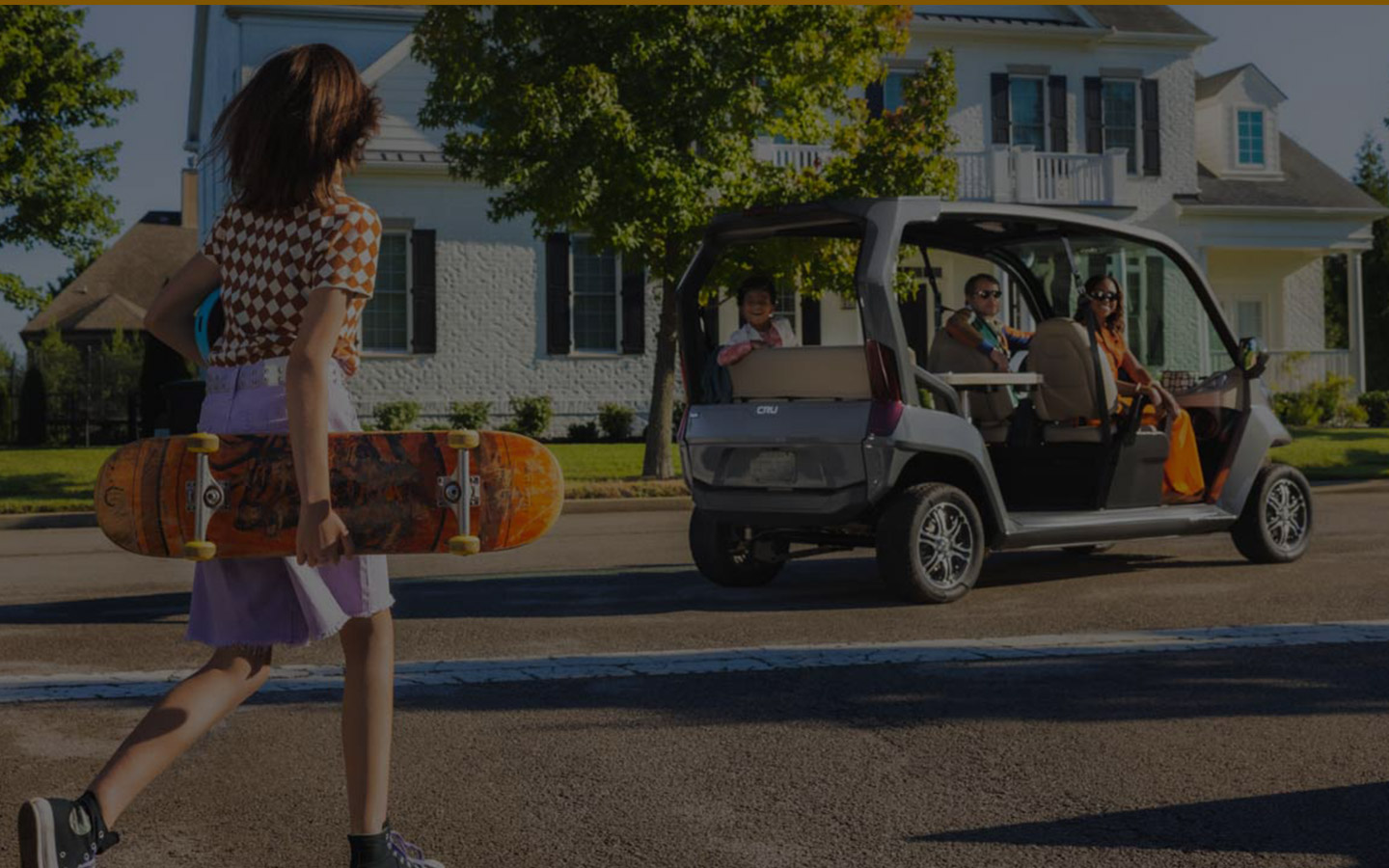 family riding around in golf cart in rich neighborhood